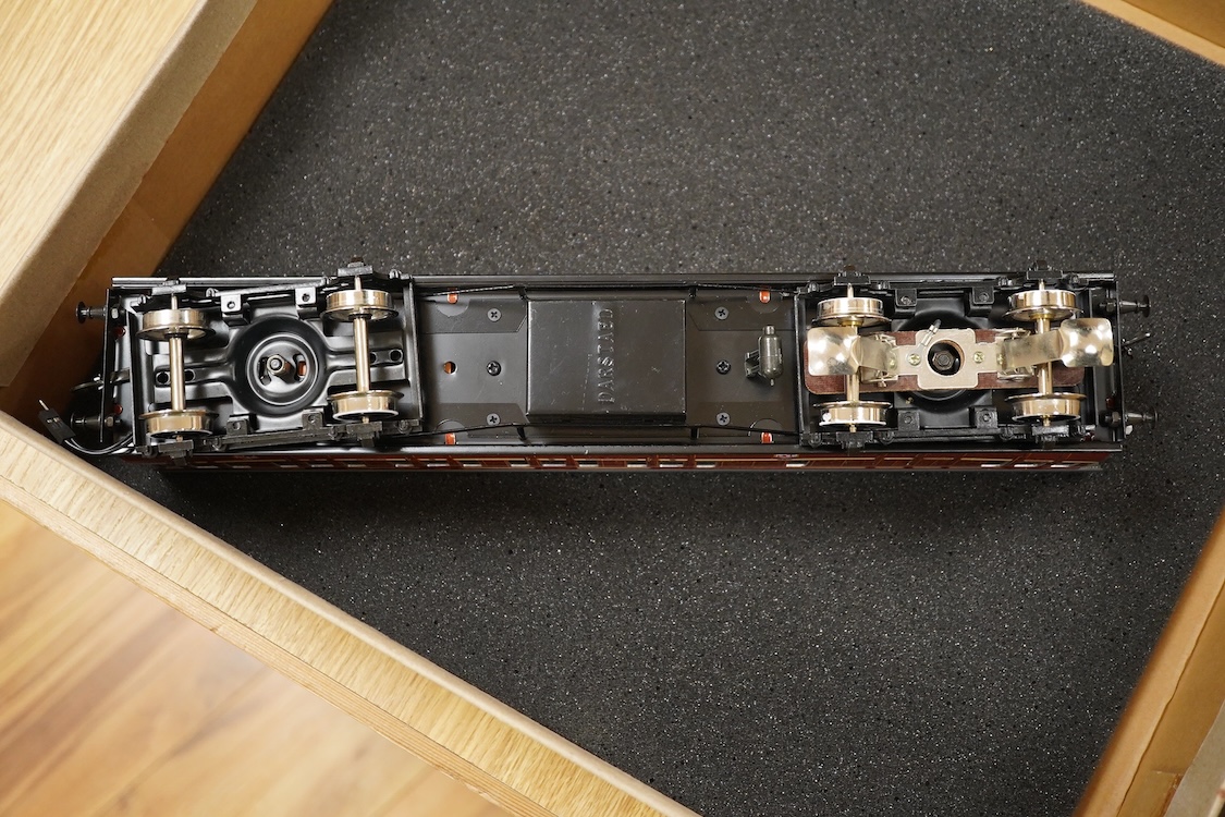 A boxed 0 gauge Darstaed tinplate Metropolitan Railway set of bogie coaches, a rake of five coaches in teak livery including; two Brake Thirds, two Full Thirds, and a Full First, fitted with internal lighting throughout